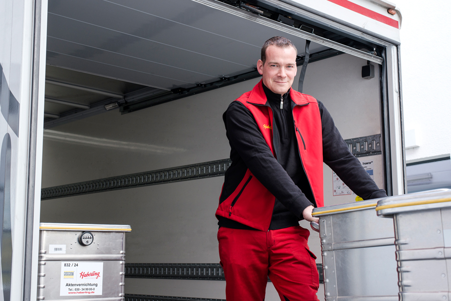 Haberling Mitarbeiter beim Beladen eines Lkw mit Sicherheitsbehältern für die Aktenvernichtung